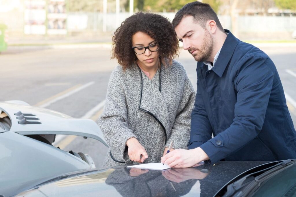 Car owner discussing repair issues with car mechanic