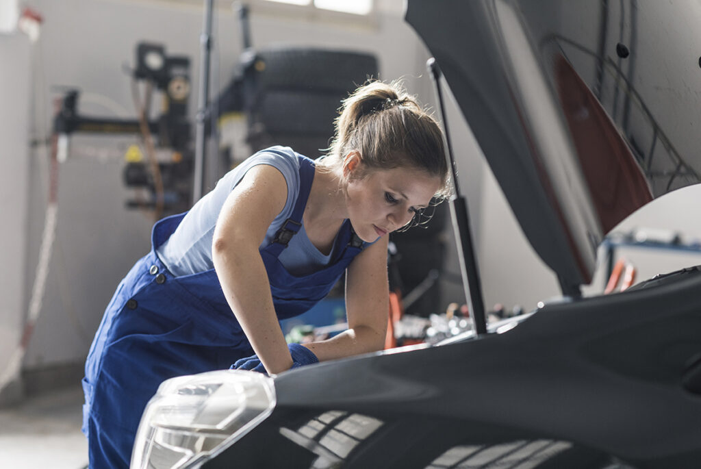 female_mechanic_checking_car