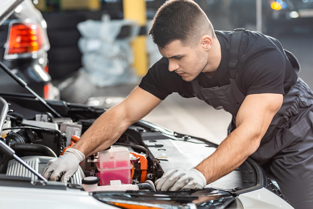 mechanic_inspecting_car_engine