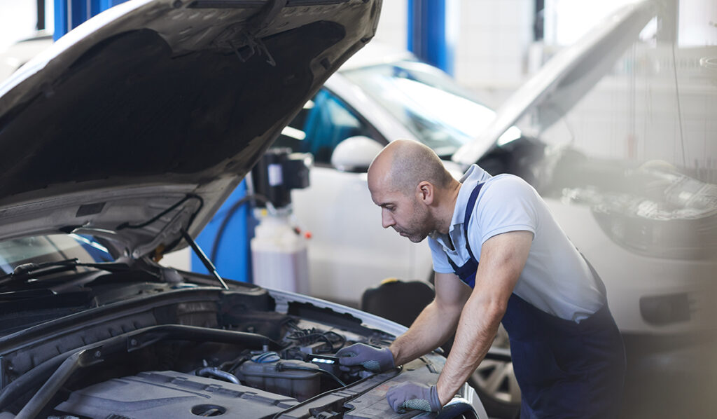 mechanic-inspecting-car-engine