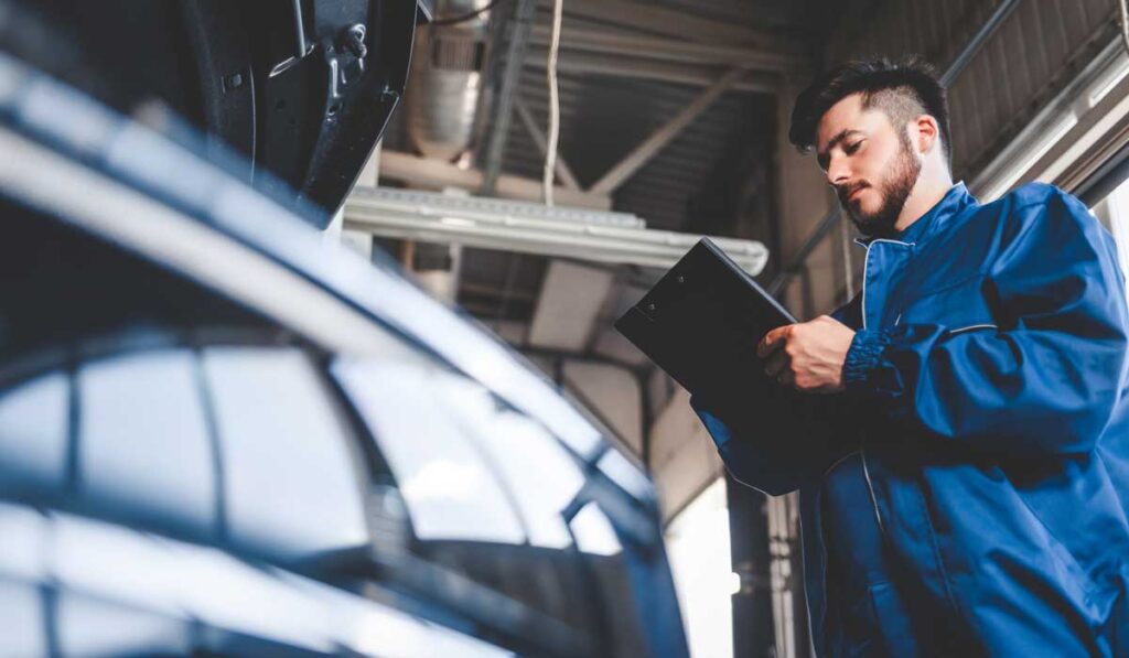 car-mechanic-writes-repair-plan-on-clipboard