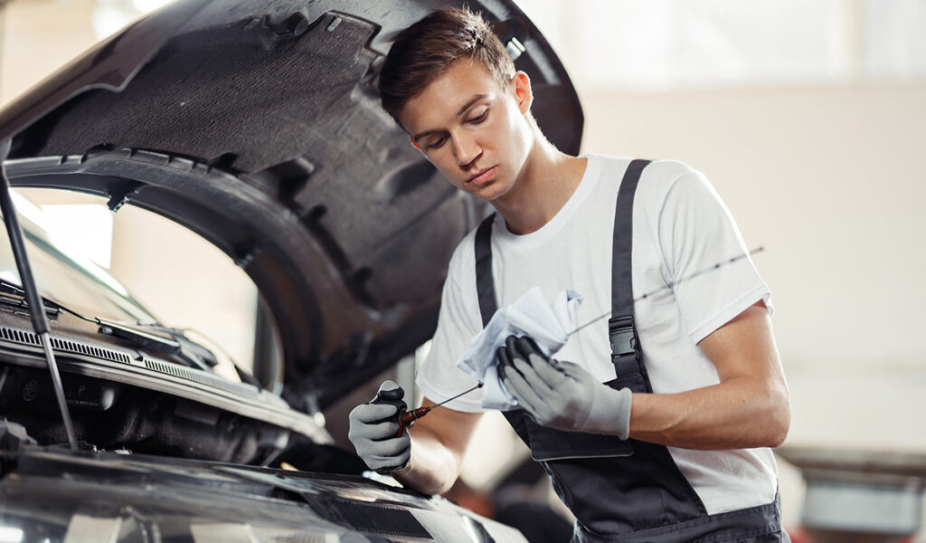 mechanic-is-checking-an-oil