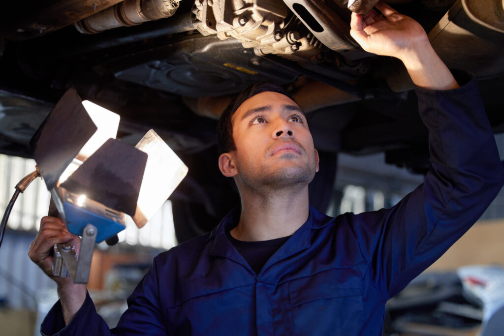 mechanic doing repairs under car