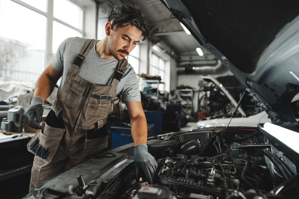 male_mechanic_examining_engine 